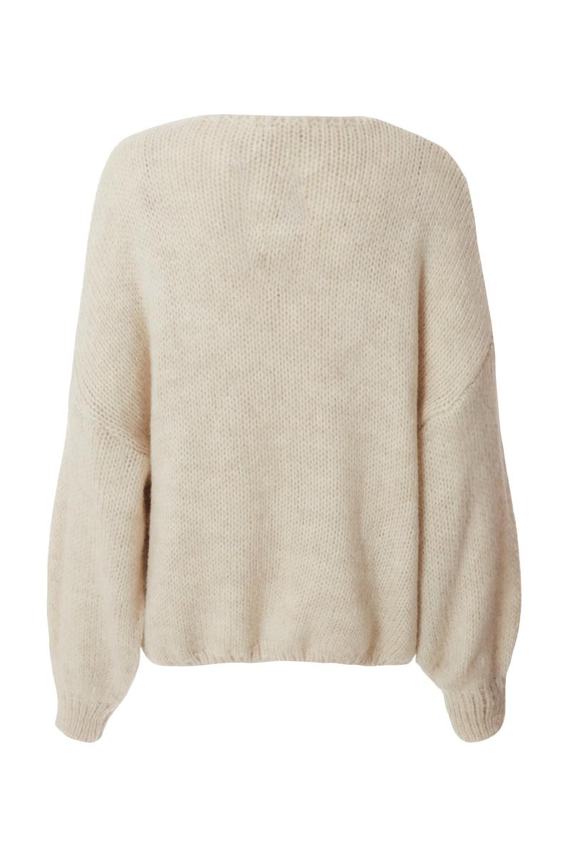 Біля білого трикотажного краватки передній кардиган